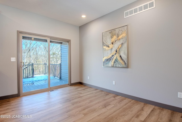 unfurnished room featuring light hardwood / wood-style floors