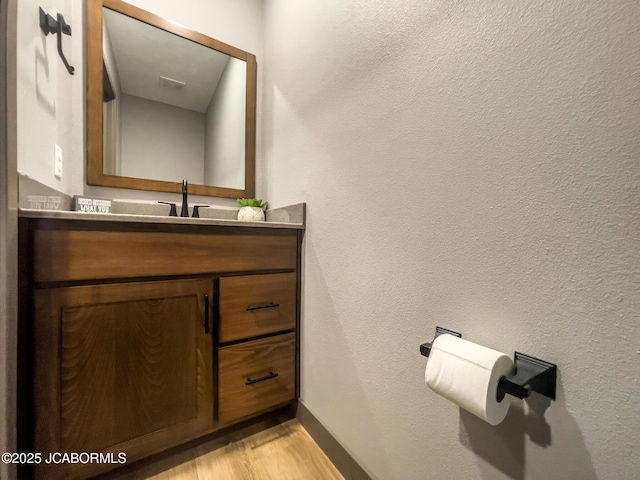 bathroom featuring vanity and hardwood / wood-style floors