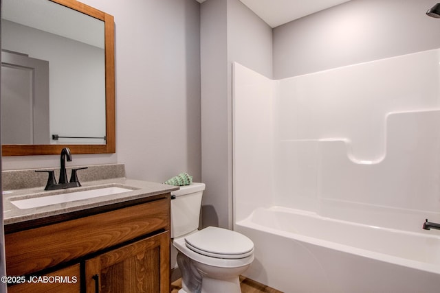 full bathroom with vanity, washtub / shower combination, and toilet