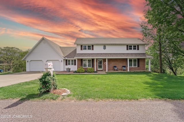 1548 Skyview, Holts Summit, MO 65043 - traditional-style home featuring an attached garage, driveway, a porch, a lawn, and brick siding