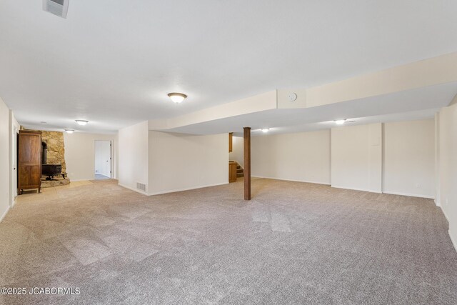 1548 Skyview, Holts Summit, MO 65043 - finished basement with light colored carpet, a wood stove, stairway, and baseboards