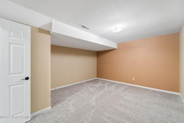 1548 Skyview, Holts Summit, MO 65043 - finished below grade area with carpet flooring, baseboards, and a textured ceiling