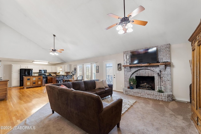 1548 Skyview, Holts Summit, MO 65043 - living room with ceiling fan, high vaulted ceiling, a brick fireplace, and light carpet