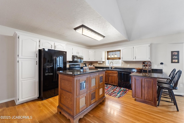 1548 Skyview, Holts Summit, MO 65043 - kitchen featuring black appliances, a peninsula, light wood-type flooring, and white cabinets