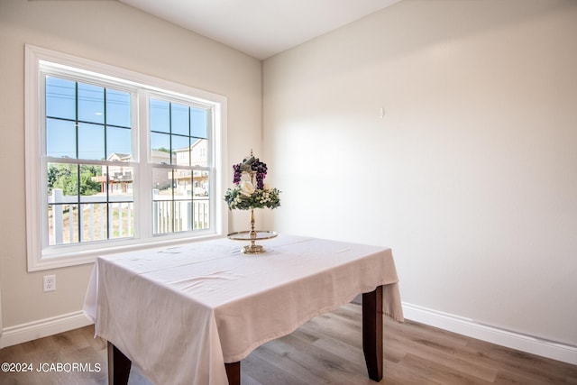 dining space featuring baseboards and light wood-type flooring