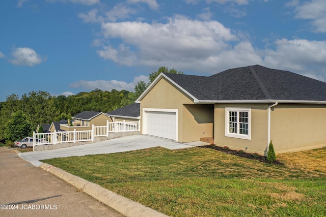 single story home featuring a front yard, roof with shingles, driveway, stucco siding, and a garage