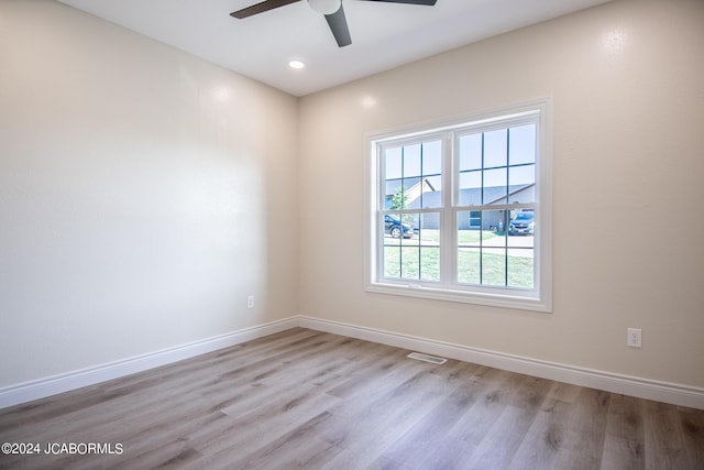 unfurnished room featuring visible vents, baseboards, recessed lighting, wood finished floors, and a ceiling fan