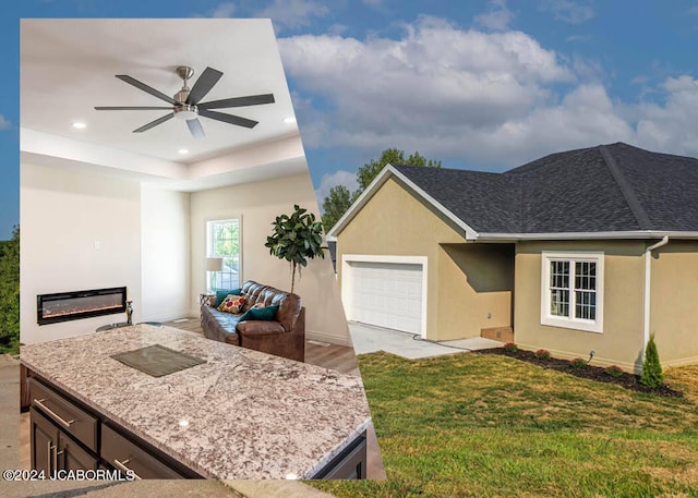 view of front of house with a front yard, a garage, and ceiling fan