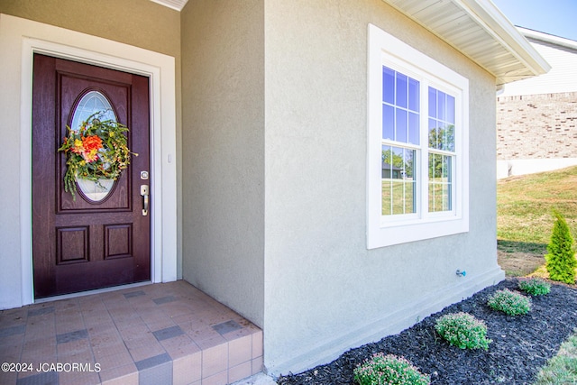 entrance to property with stucco siding