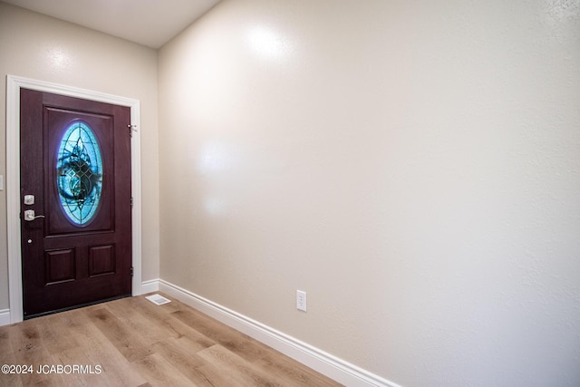 foyer entrance featuring light wood-type flooring, baseboards, and visible vents