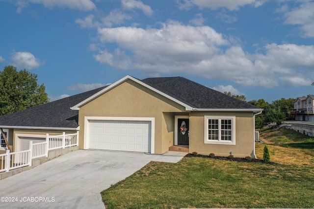 ranch-style home with stucco siding, driveway, a shingled roof, an attached garage, and a front yard