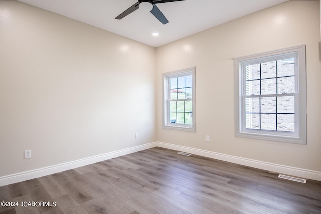 empty room featuring hardwood / wood-style flooring and ceiling fan