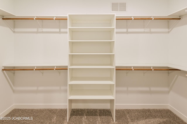 walk in closet featuring carpet flooring and visible vents