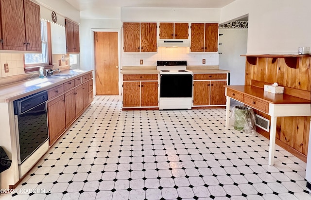 kitchen featuring backsplash, white range with electric stovetop, dishwasher, and sink