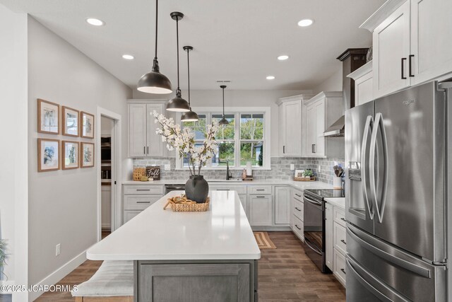 15005 Wrangle Ln, Ashland, MO 65010 - kitchen featuring a kitchen island, light countertops, stainless steel refrigerator with ice dispenser, electric range, and white cabinetry