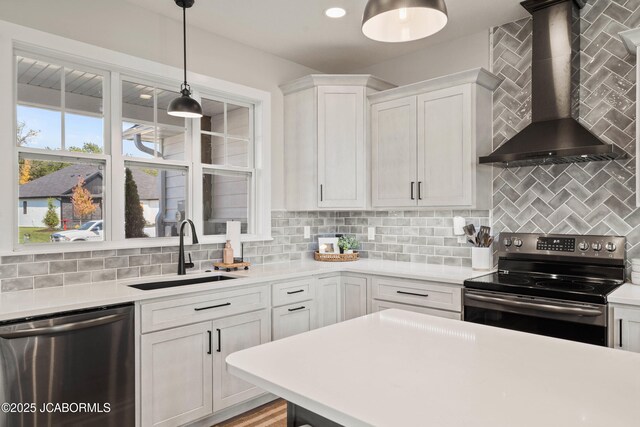 15005 Wrangle Ln, Ashland, MO 65010 - kitchen with a sink, light countertops, appliances with stainless steel finishes, wall chimney exhaust hood, and backsplash