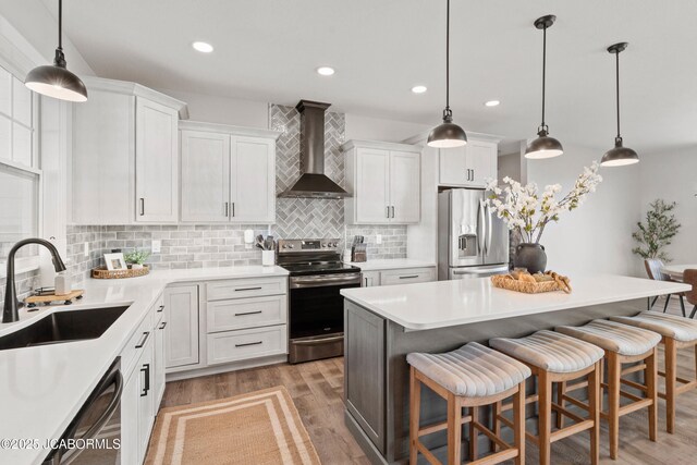 15005 Wrangle Ln, Ashland, MO 65010 - kitchen featuring a sink, wall chimney range hood, white cabinetry, and stainless steel appliances