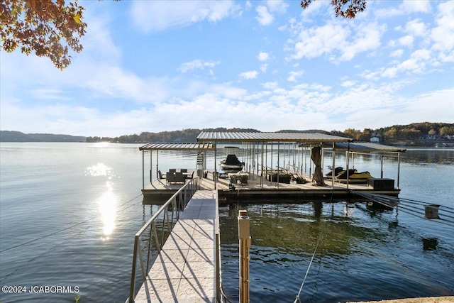 view of dock featuring boat lift and a water view