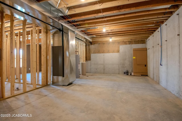 basement featuring water heater and heating unit