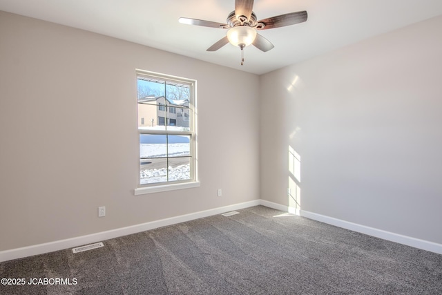 carpeted spare room with ceiling fan