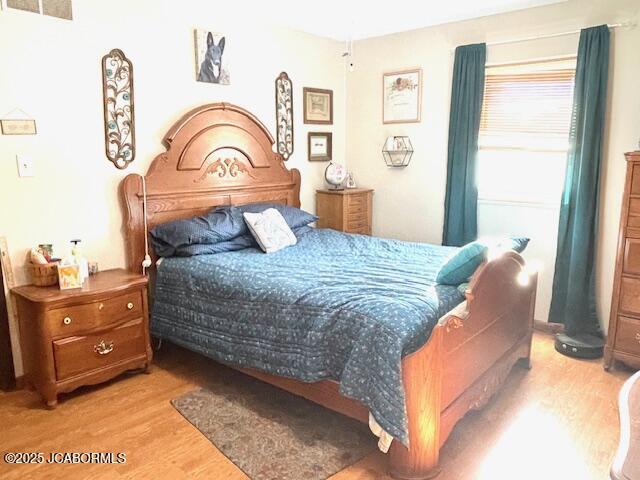 bedroom with light wood-type flooring