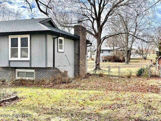 view of side of home featuring a yard