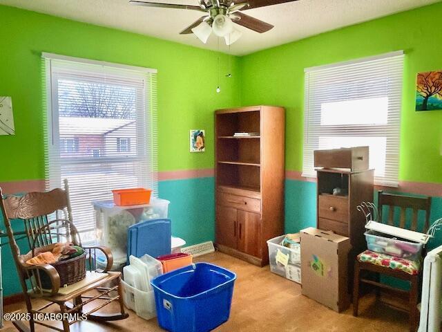 living area with ceiling fan