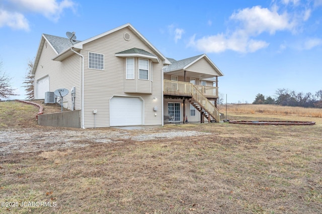 31500 Skyline Dr, California, MO 65018 - back of house with stairway, a garage, a wooden deck, and a lawn