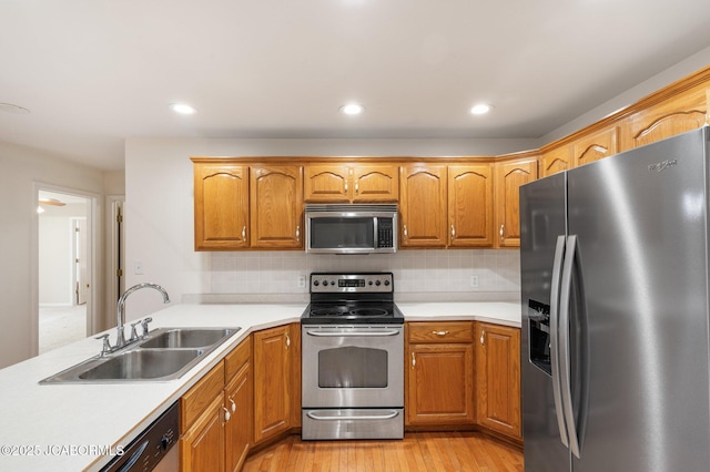 31500 Skyline Dr, California, MO 65018 - kitchen with appliances with stainless steel finishes, light countertops, light wood-style flooring, tasteful backsplash, and recessed lighting