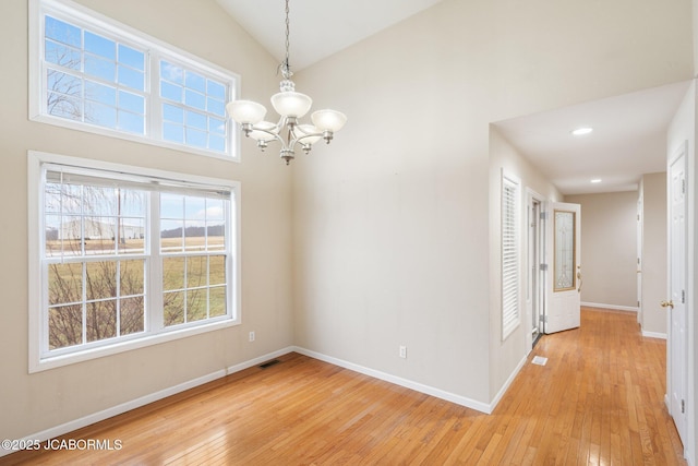 31500 Skyline Dr, California, MO 65018 - empty room featuring light wood finished floors, a chandelier, high vaulted ceiling, and recessed lighting