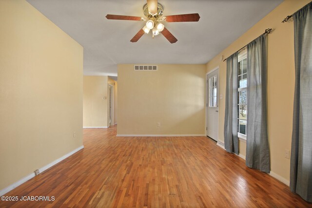 foyer entrance featuring ceiling fan, a wealth of natural light, and wood-type flooring