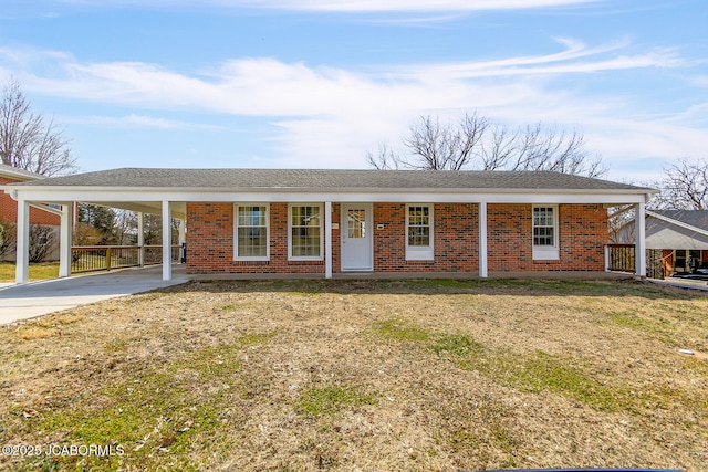 ranch-style home with an attached carport, concrete driveway, and brick siding