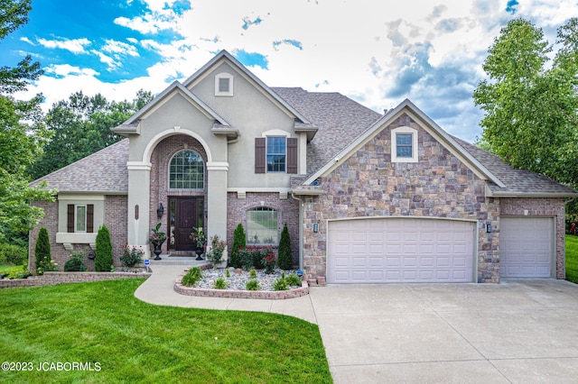 view of front of home with a front lawn and a garage