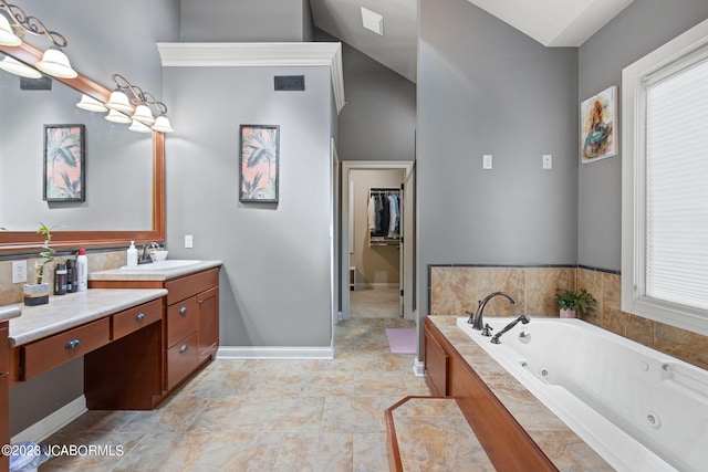 bathroom featuring vanity and tiled bath