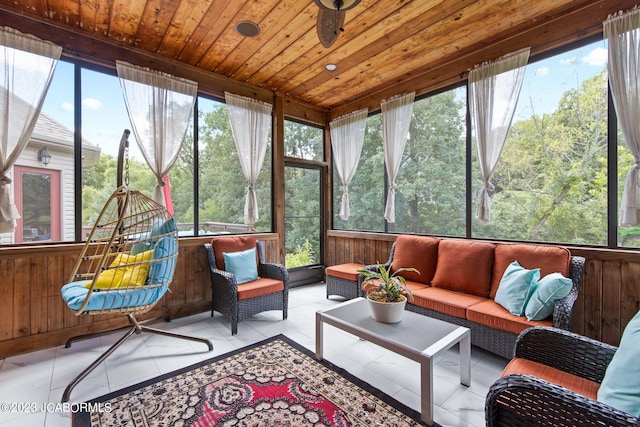 sunroom / solarium featuring plenty of natural light, ceiling fan, and wood ceiling