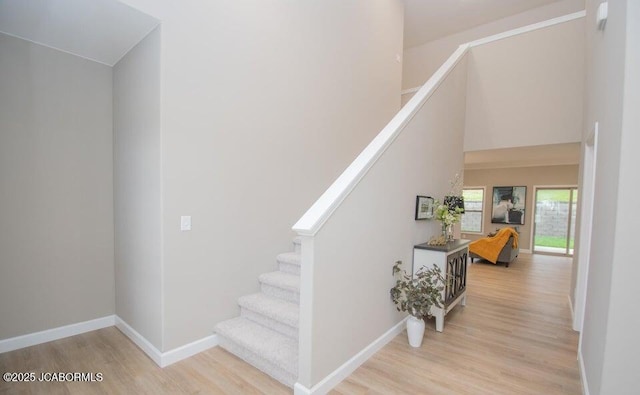 stairs featuring hardwood / wood-style floors