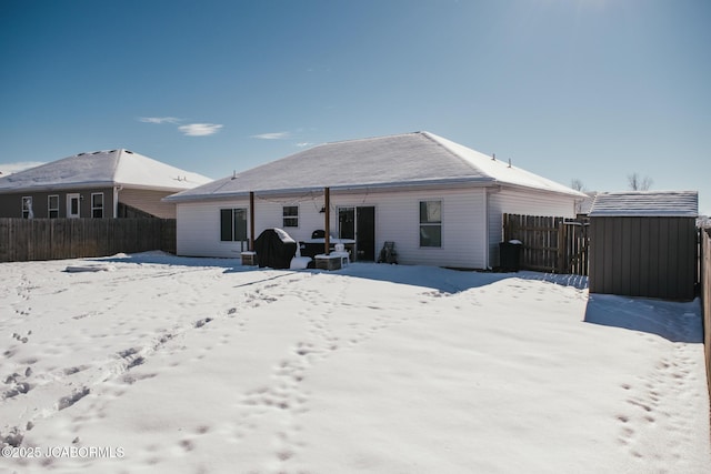 view of snow covered back of property