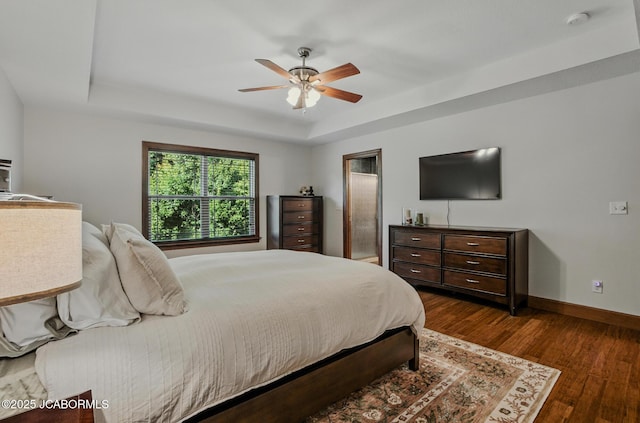 5004 Bates Creek Ct, Columbia, MO 65201 - bedroom with a tray ceiling, dark wood finished floors, and ceiling fan