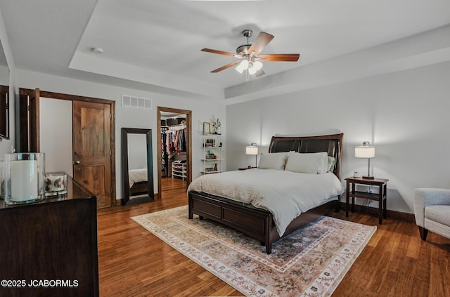 5004 Bates Creek Ct, Columbia, MO 65201 - bedroom with wood finished floors, a spacious closet, ceiling fan, a closet, and a tray ceiling