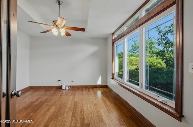 5004 Bates Creek Ct, Columbia, MO 65201 - unfurnished room with wood finished floors, plenty of natural light, and a ceiling fan
