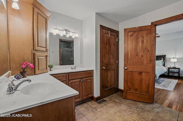5004 Bates Creek Ct, Columbia, MO 65201 - bathroom featuring two vanities, a shower, and tile patterned floors