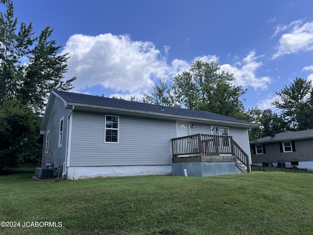 back of property featuring a yard and cooling unit