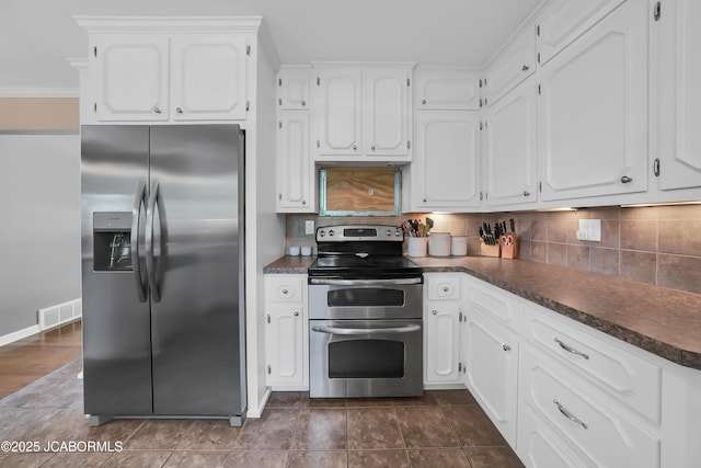 2213 Tanner Bridge Rd, Jefferson City, MO 65101 - kitchen with appliances with stainless steel finishes, dark countertops, white cabinetry, and decorative backsplash