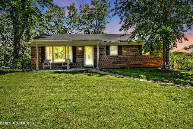 2213 Tanner Bridge Rd, Jefferson City, MO 65101 - ranch-style house featuring brick siding, a front lawn, and a porch