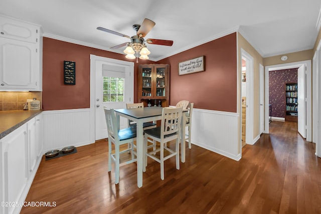 2213 Tanner Bridge Rd, Jefferson City, MO 65101 - dining area with a wainscoted wall, wood finished floors, a ceiling fan, and ornamental molding