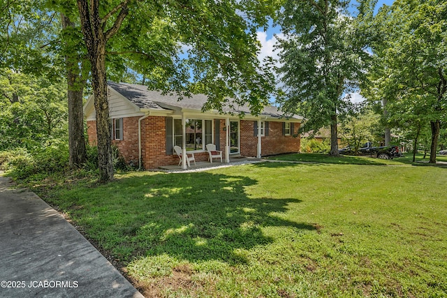 2213 Tanner Bridge Rd, Jefferson City, MO 65101 - single story home with brick siding, a patio, and a front yard