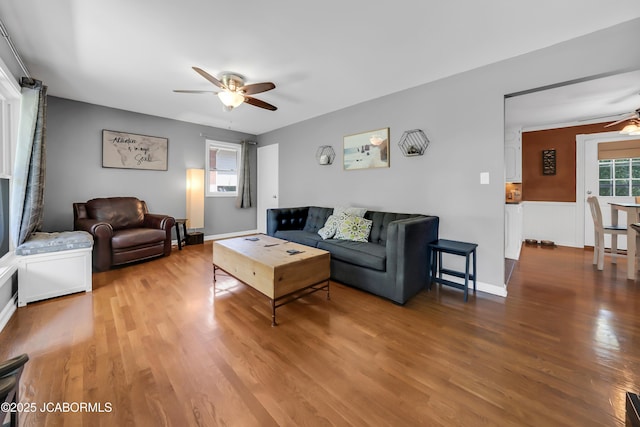 2213 Tanner Bridge Rd, Jefferson City, MO 65101 - living room featuring a ceiling fan, wood finished floors, and wainscoting