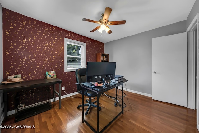 2213 Tanner Bridge Rd, Jefferson City, MO 65101 - office featuring wallpapered walls, a ceiling fan, wood finished floors, and an accent wall