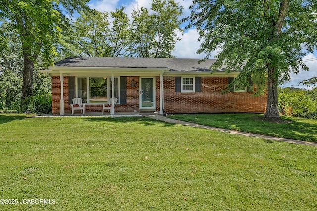 2213 Tanner Bridge Rd, Jefferson City, MO 65101 - ranch-style home with brick siding, a front yard, and covered porch