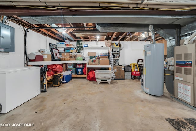 2213 Tanner Bridge Rd, Jefferson City, MO 65101 - unfinished below grade area featuring fridge, electric panel, gas water heater, and heating unit